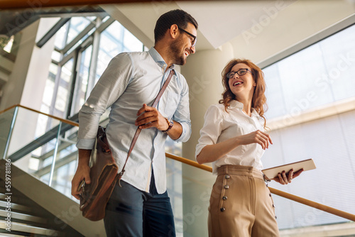 Group of young business people working and communicating at the office