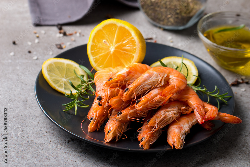 Shrimps on stone background. Grilled prawns with rosemary and lemon. Shrimps on stone background. Grilled prawns with rosemary and lemon.