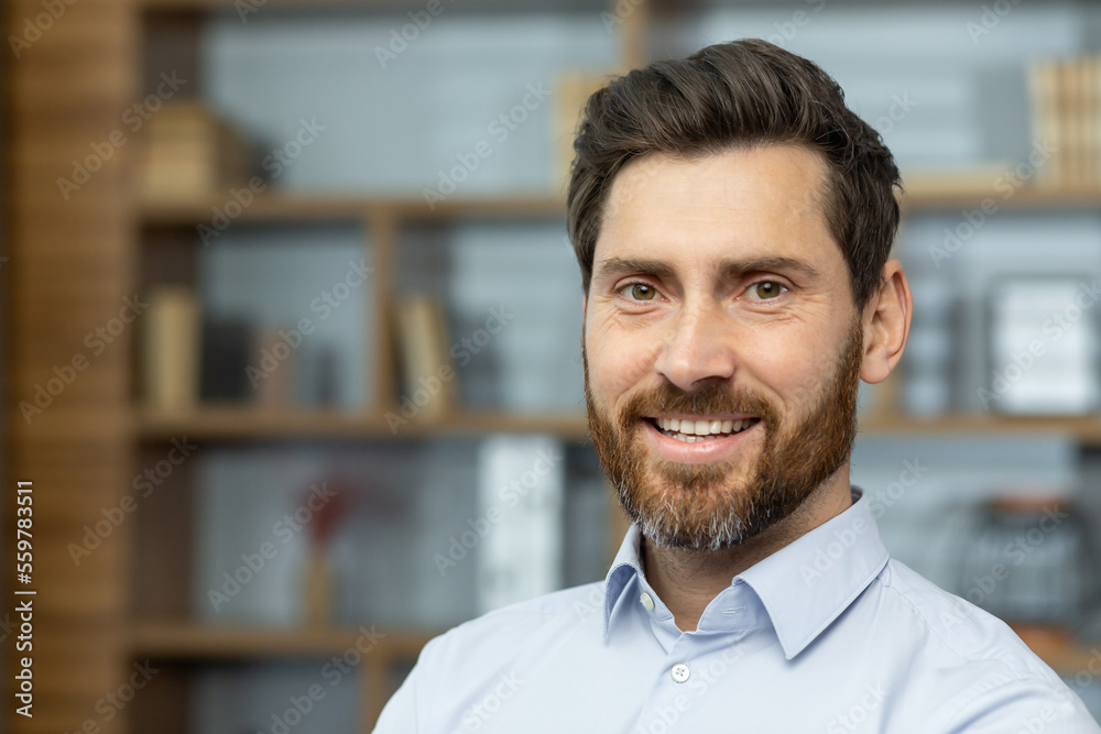 Obraz premium Close up businessman in shirt smiling and looking at camera, successful man inside office satisfied with achievement results, mature investor financier headshot.