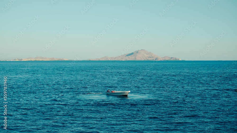 a small boat in the middle of the sea