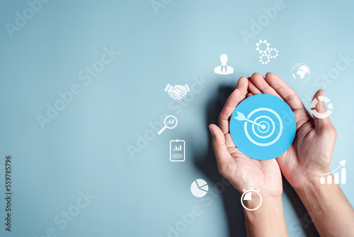 Business hands holding target icon, dartboard and arrow for creative and set up business objective target goal, marketing solution, target for business investment.