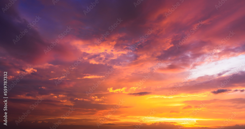 Evening sunset sky clouds with dramatic orange sunlight storm clouds, dusk sky on twilight nature background 