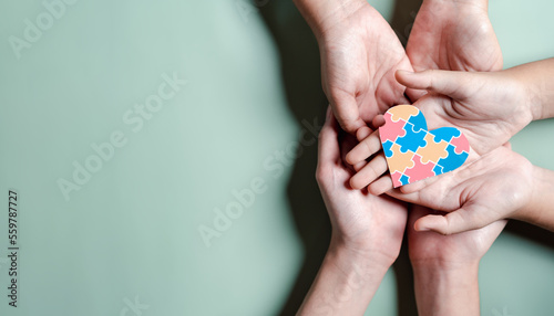 Father, Mother, Children holding heart jigsaw puzzle, Color puzzle symbol of awareness for autism spectrum disorder family support. Autism World Awareness Day.