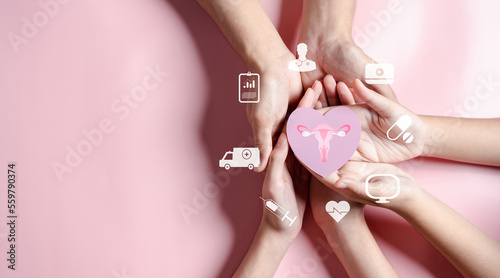 Hands holding uterus in heart shape, female reproductive system, women's health, PCOS, ovary gynecologic and cervical cancer, Health insurance, Healthy feminine concept photo