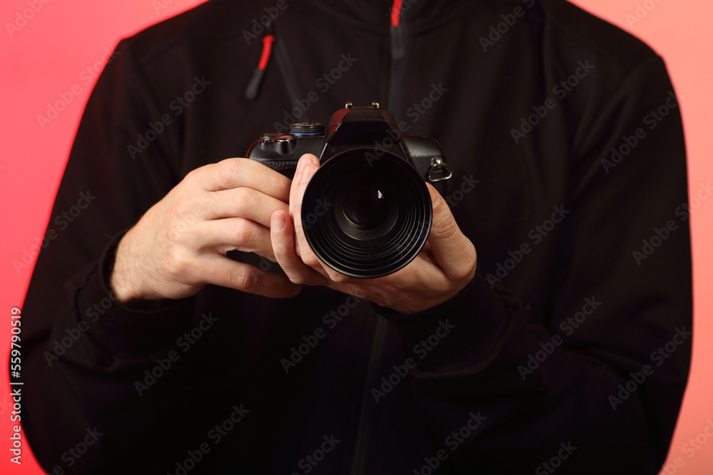 a young person takes a photo with a digital SLR camera with an old lens a young person takes a photo with a digital SLR camera with an old lens