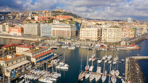 Aerial view of the waterfront and historic center of Naples, Italy. In the background Castel Sant' Elmo on the Vomero hill.