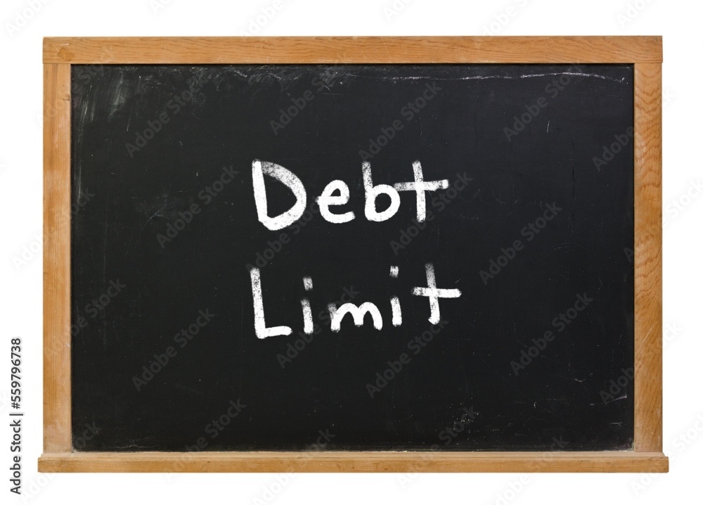 Debt ceiling limit written in white chalk on a black chalkboard isolated on white