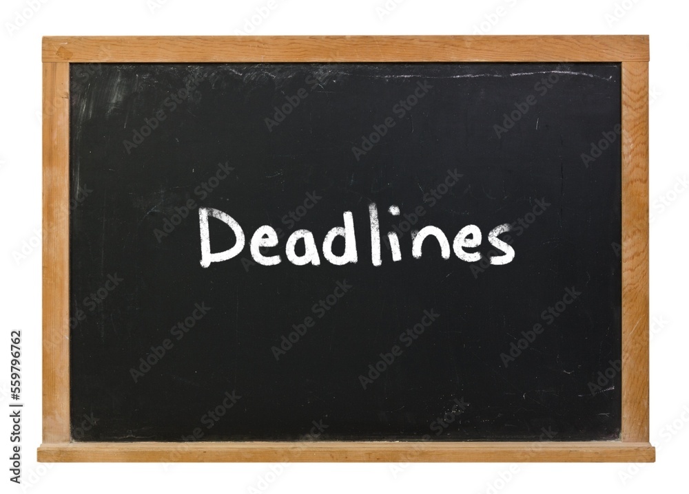 Deadlines written in white chalk on a black chalkboard isolated on white Deadlines written in white chalk on a black chalkboard isolated on white