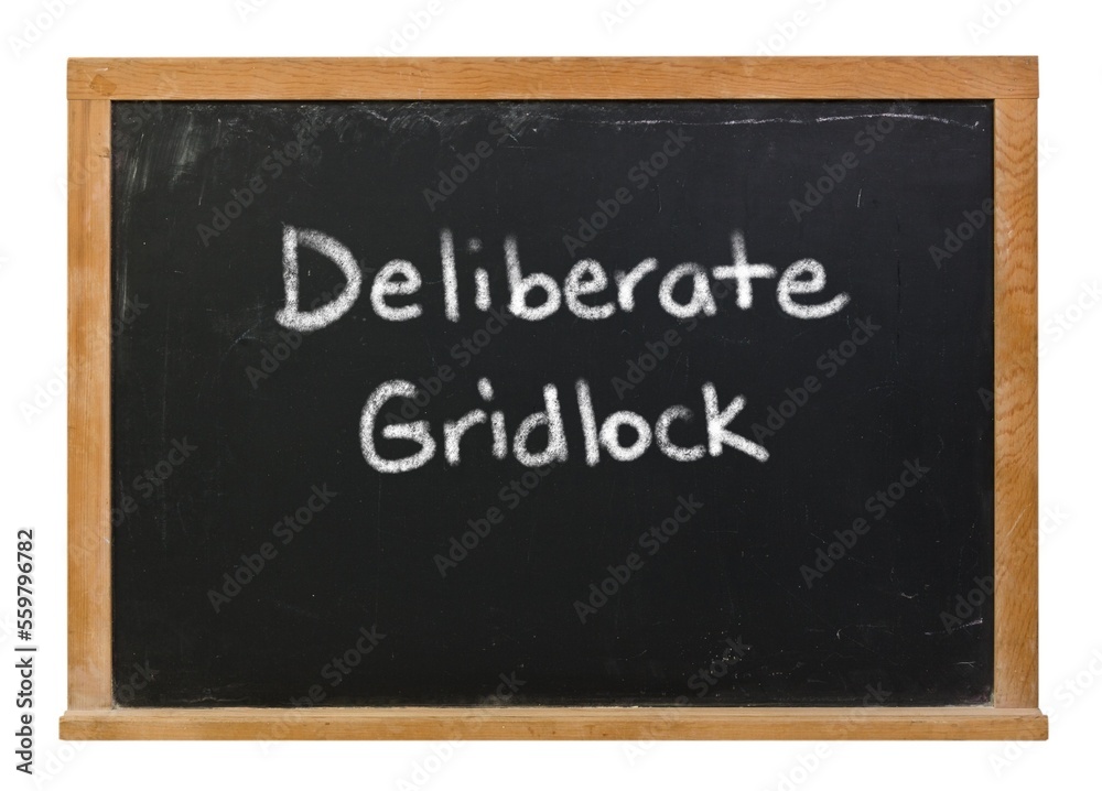 Deliberate gridlock written in white chalk on a black chalkboard isolated on white Deliberate gridlock written in white chalk on a black chalkboard isolated on white