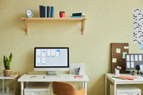 Fotografie Background image of minimal office setup with computer screen and planning chart