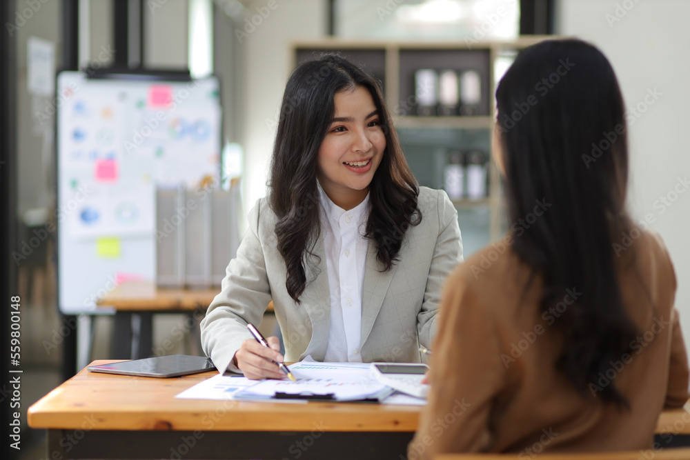 Happy businesswomen colleagues discussing in the office, Planning collaboration and participation of people in the organization. Happy businesswomen colleagues discussing in the office, Planning collaboration and participation of people in the organization.
