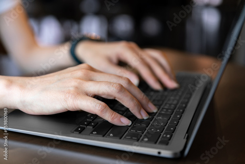 closeup hand typing keyboard on labtop of businesswoman during technology online connection business work for education and study business concept