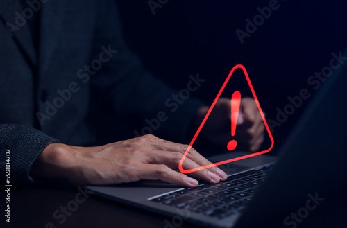 Businessman working on the computer. Warning alert system concept, hacked on the computer network, crime and virus, Malicious software, compromised information, illegal connection, data vulnerability,