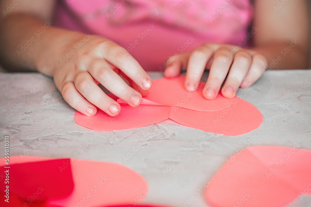 DIY holiday card with a red paper heart, a symbol of love. child makes Mother's Day, Valentine's Day, greeting card. Hobby, art concept, DIY gift