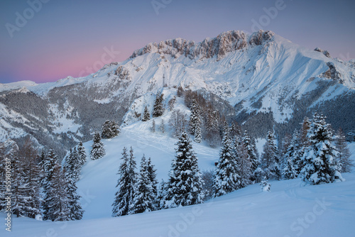 Sunrise in the mountains Winter landscape with snowy peaks and trees, Italian Alps, Lombardy, Italy. © Andrea