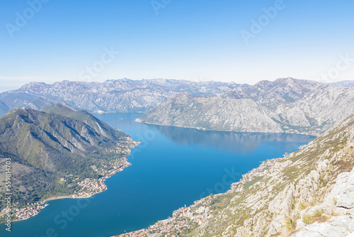 Panoramic view from Derinski Vrh (Pestingrad) of Kotor bay on sunny summer day, Adriatic Mediterranean Sea, Montenegro, Balkan, Europe. Fjord winding along coastal towns. Lovcen, Orjen mountain range