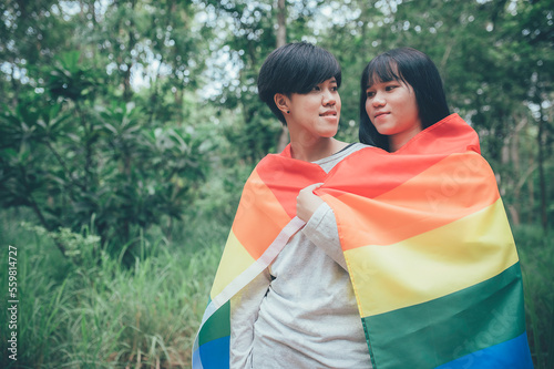 Couple of girl with girl,LGBT Pride month concept,Asian Handsome male make up and wear woman cloth,Gay Freedom Day,Portrait of Non-binary on white background photo