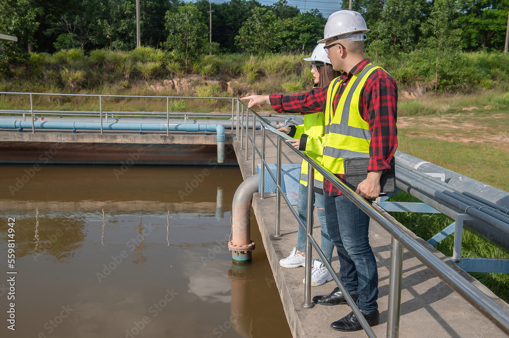 Environmental engineers work at wastewater treatment plants,Water supply engineering working at Water recycling plant for reuse,Technicians and engineers discuss work together.