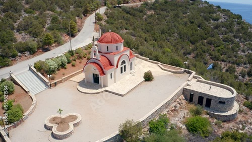 4K aerial - a bird's eye view video (Ultra High Definition) of Greek Orthodox church St. Gerasimos. Exciting summer seascape of Myrtoa sea, Peloponnese, Greece, Europe. photo