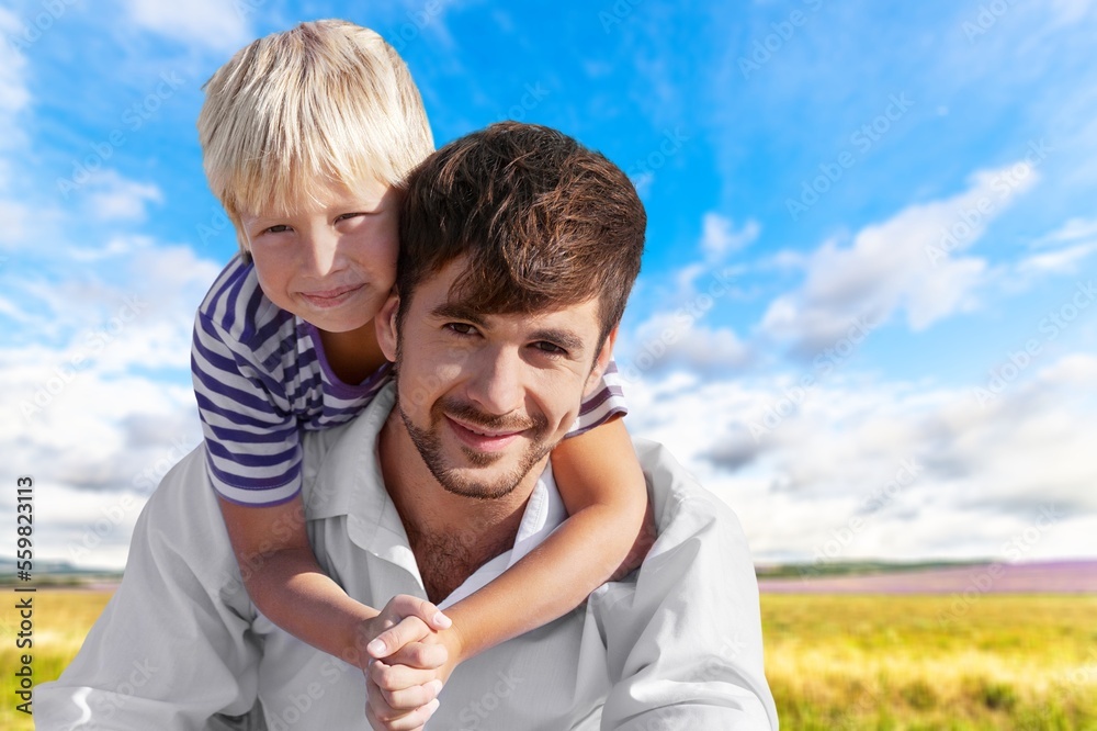 Obraz premium Happy young father play with cute child in park