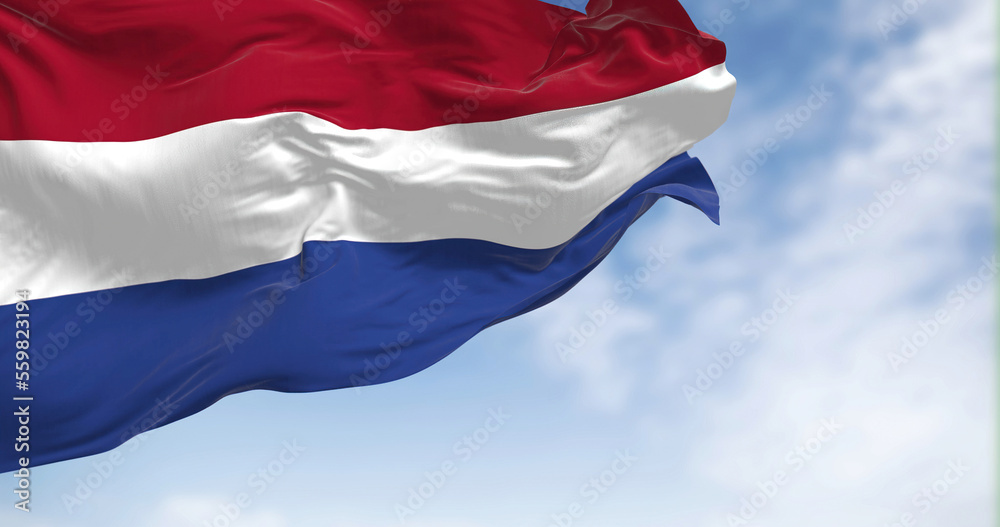 The national flag of the Netherlands waving in the wind on a sunny day The national flag of the Netherlands waving in the wind on a sunny day