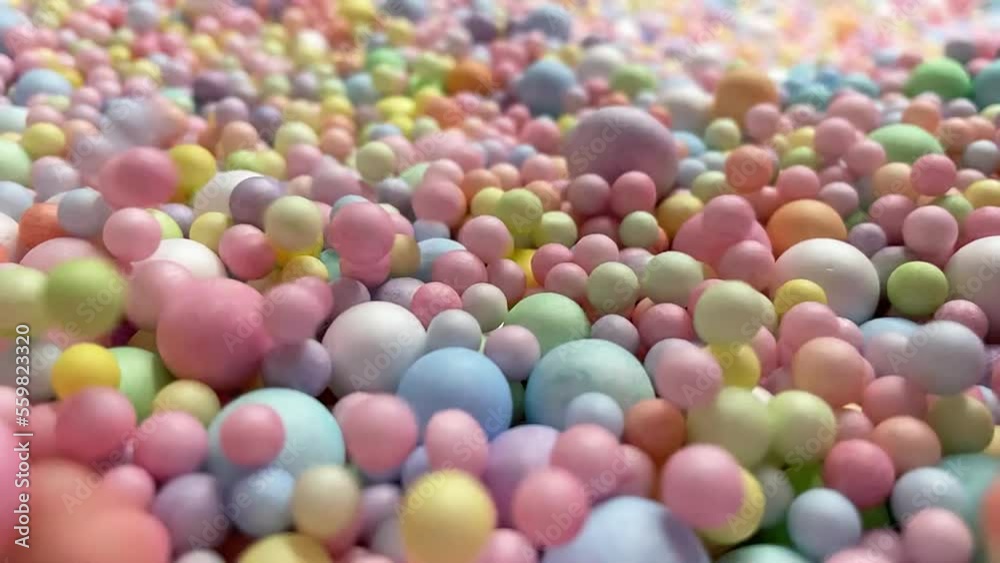 Many colorful rainbow foam balls balloons. Pile of multicolor spheres rolling, falling and flying. Many colorful rainbow foam balls balloons. Pile of multicolor spheres rolling, falling and flying.