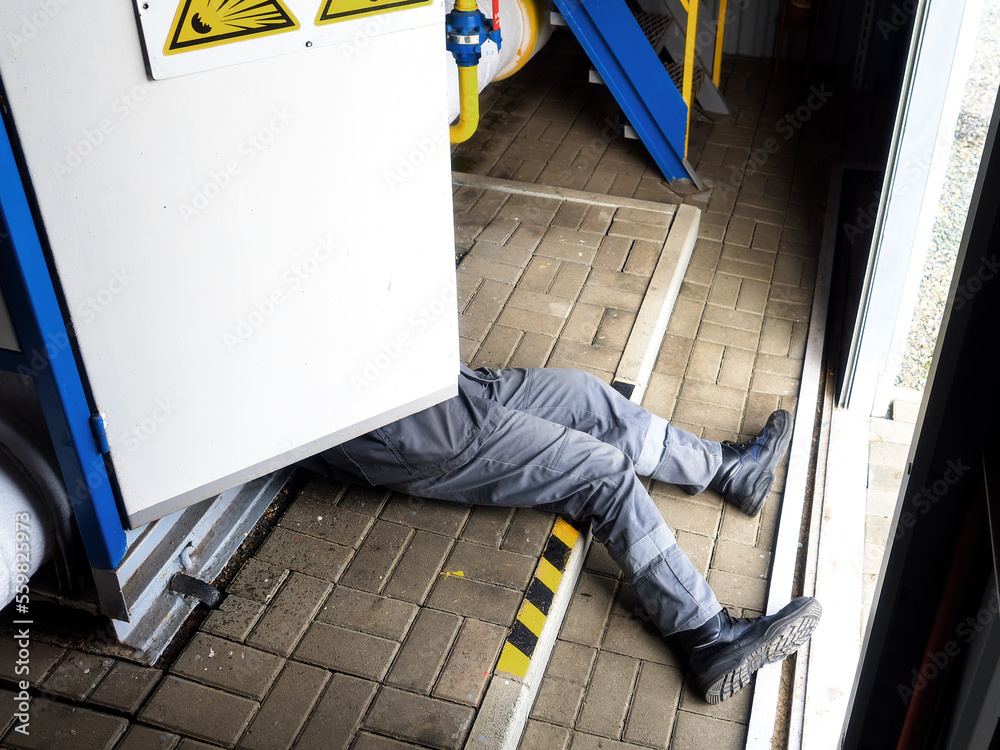 Accident. Electric shock to person. Out of electric panel stick out legs of  worker. Electrician is electrocuted and lies on floor at production site.  Compliance with labor protection.. Stock Photo | Adobe
