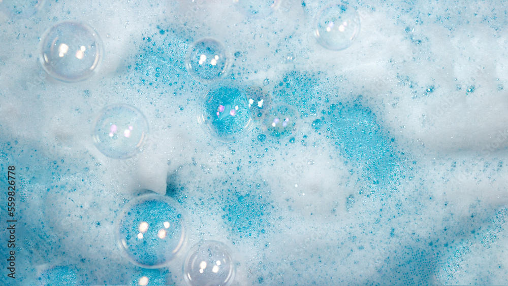 Soap foam on the water on a blue background. Foam texture as background for image. Soap bubbles on the background of foam Soap foam on the water on a blue background. Foam texture as background for image. Soap bubbles on the background of foam