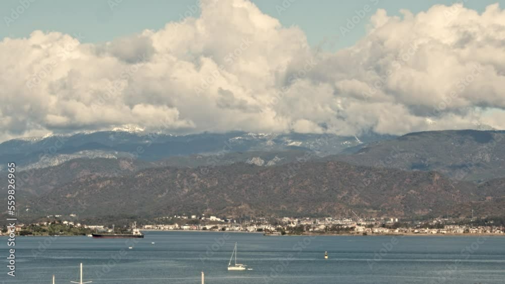 A coastal city for recreation. Big clouds over the southern city. Landscape of the city in the mountains A coastal city for recreation. Big clouds over the southern city. Landscape of the city in the mountains