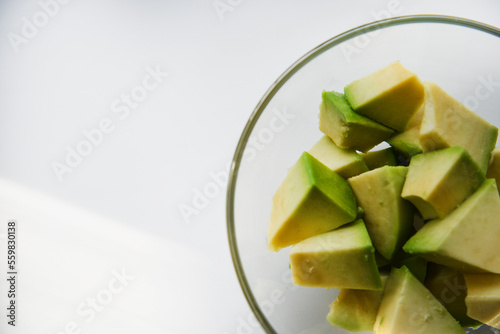 Avocado cut into small slices. Avocado salad. Peeled avocado on a plate.