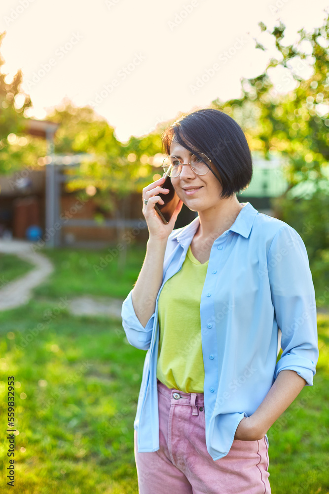 Happy woman in glasses talking on mobile phone outdoor, Happy woman in glasses talking on mobile phone outdoor,
