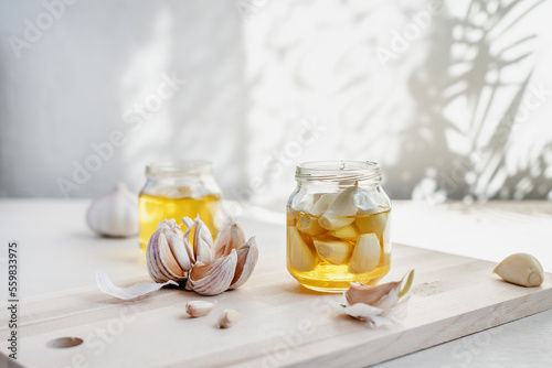 Принти на полотні Fermented garlic cloves in a jar of honey