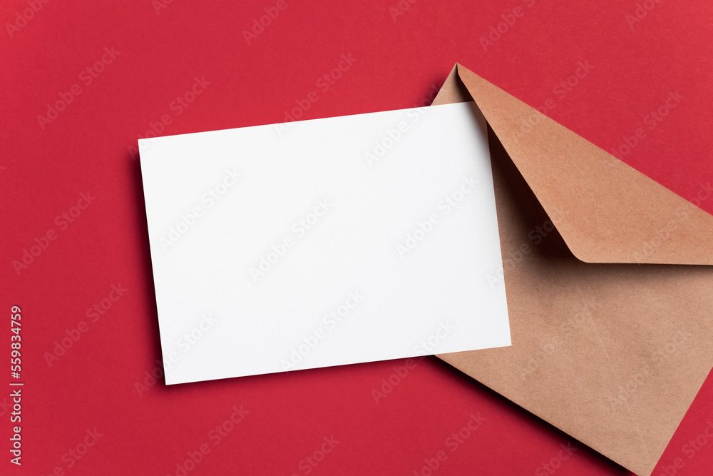Invitation or greeting card mockup with envelope on red paper background Invitation or greeting card mockup with envelope on red paper background