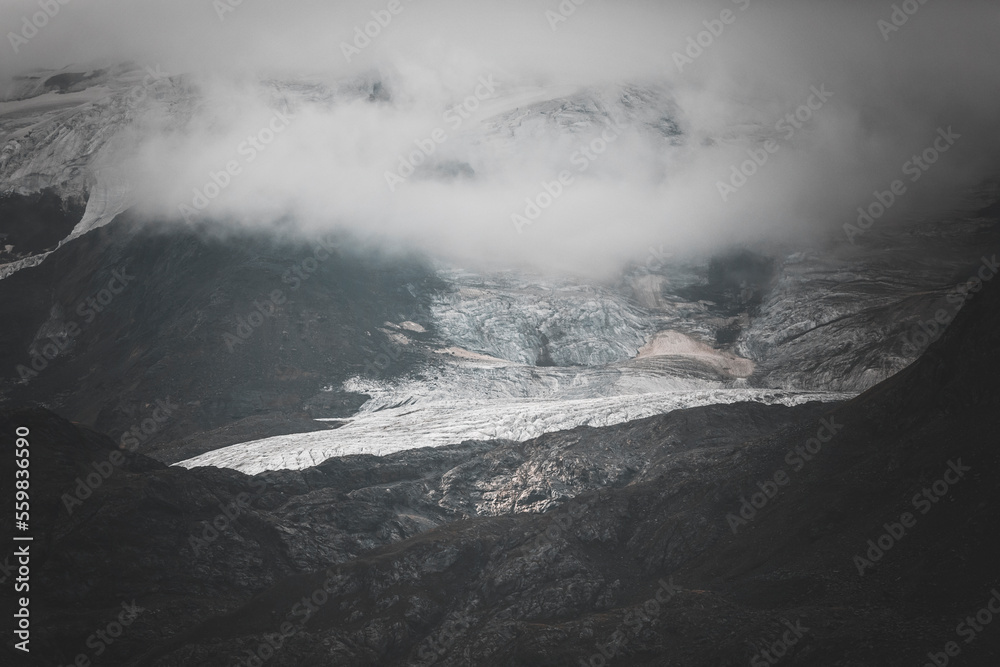 glacier in the mountains on a cloudy day