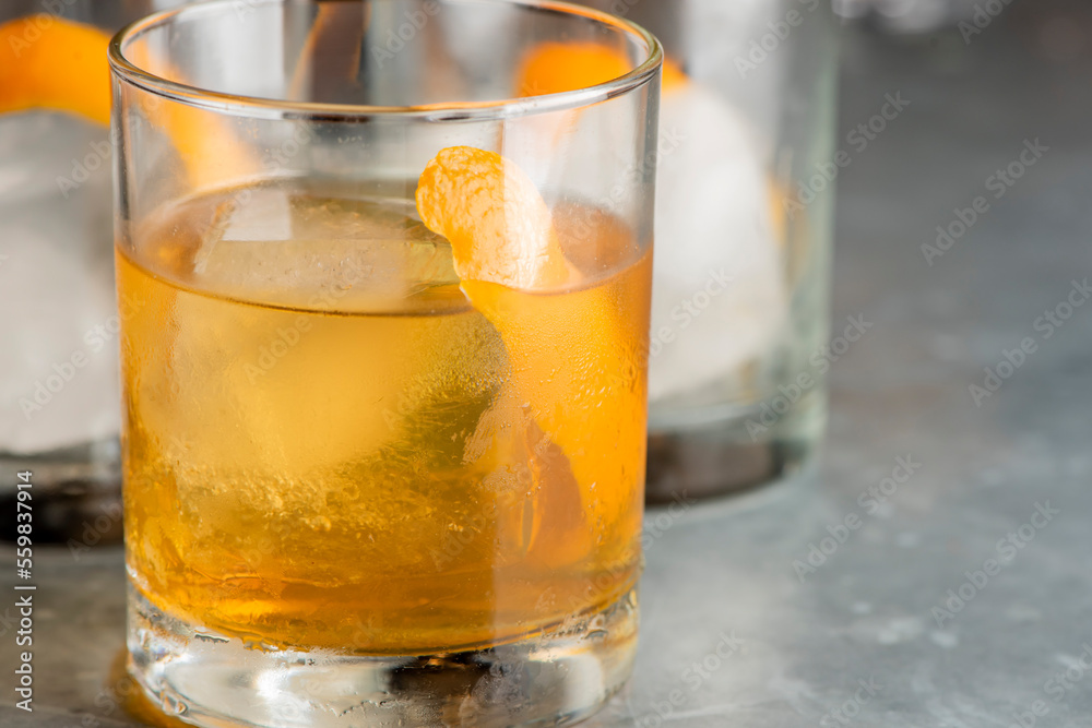 Old fashioned or Manhattan cocktail. Classic American drink with rye whiskey or bourbon, muddled maraschino cherries, oranges and sugar. Shaken, served over ice and garnished with an orange peel. Old fashioned or Manhattan cocktail. Classic American drink with rye whiskey or bourbon, muddled maraschino cherries, oranges and sugar. Shaken, served over ice and garnished with an orange peel.