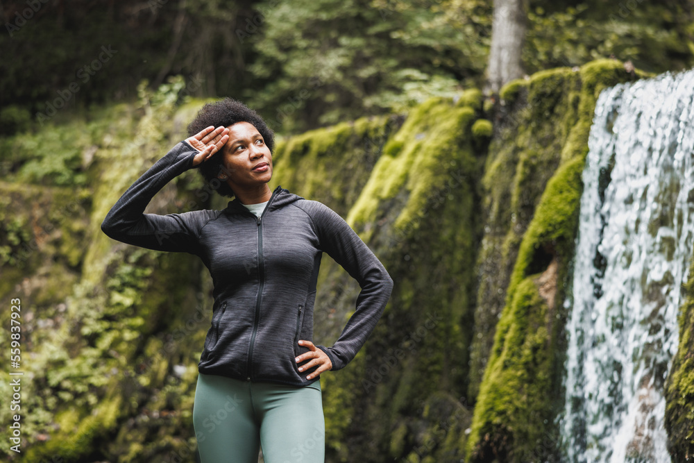 Black Woman Enjoying Before Running Near The Waterfall In Nature Black Woman Enjoying Before Running Near The Waterfall In Nature