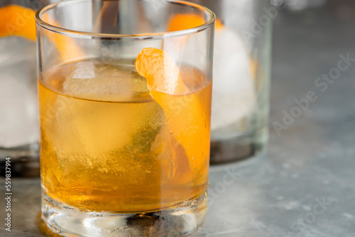 Old fashioned or Manhattan cocktail. Classic American drink with rye whiskey or bourbon, muddled maraschino cherries, oranges and sugar. Shaken, served over ice and garnished with an orange peel.