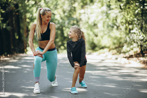 Mother with daughter jogging in park