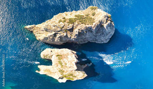 Amazing aerial view of Faraglioni Rocks over the sea in Capri Island, Italy. Drone viewpoint