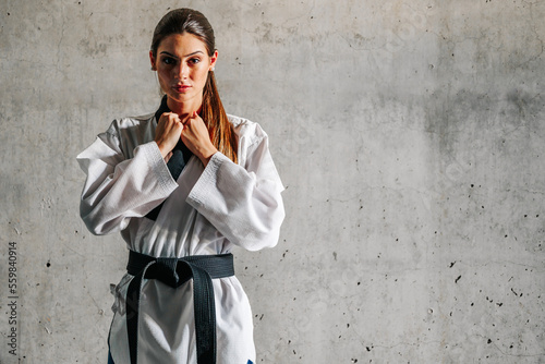Confident woman in taekwondo coat photo