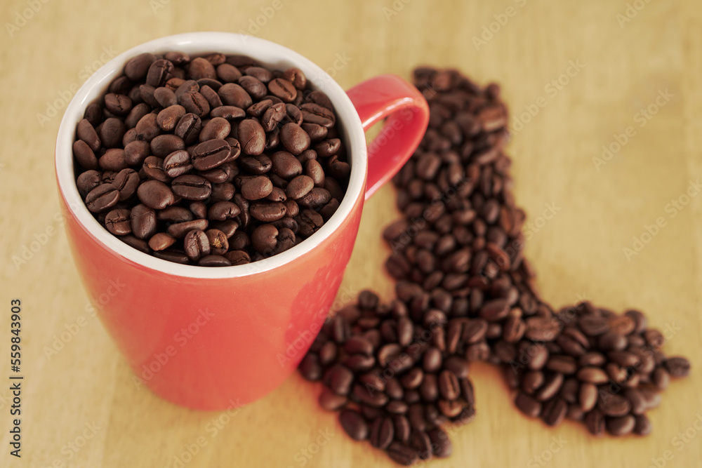 coffee beans in a cup on table coffee beans in a cup on table