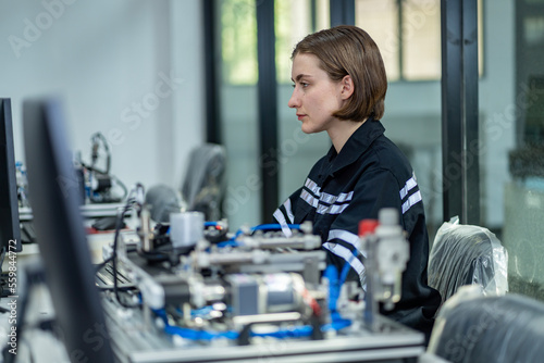 Team woman of engineers practicing maintenance Taking care and practicing maintenance of old machines in the factory so that they can be used continuously.