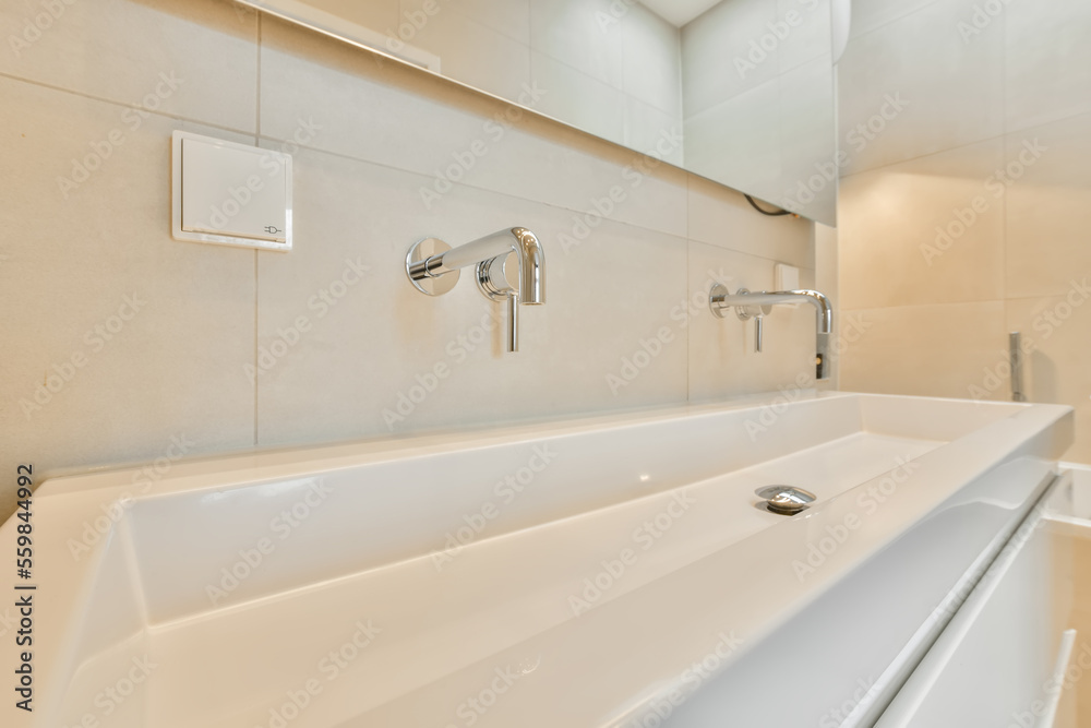 Sink next to a mirror with white walls Sink next to a mirror with white walls