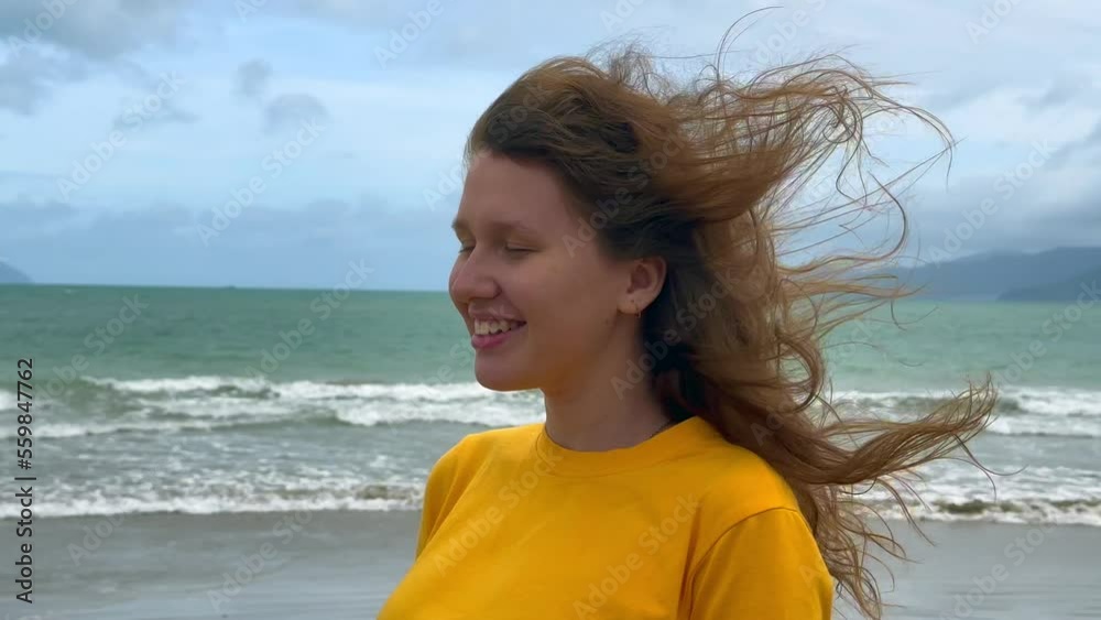 Portrait of happy positive red hair girl, young beautiful carefree woman enjoying summer vacation at sea, beach in exotic tropical country Portrait of happy positive red hair girl, young beautiful carefree woman enjoying summer vacation at sea, beach in exotic tropical country
