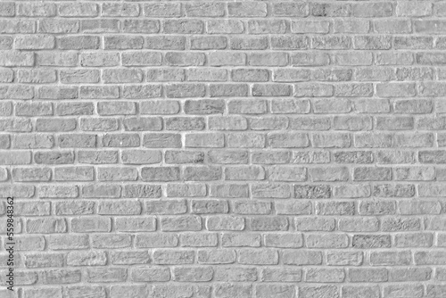 Old grungy retro bright brick wall of ancient city. Uneven clear pitted peeled surface brickwork of cellar worn. Ruined solid bumpy stiff blocks. Hard beautiful brickwall for 3D grunge minimal design