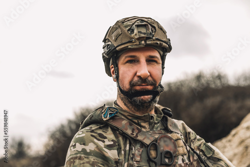 Mature man in military uniform and protective hemlet