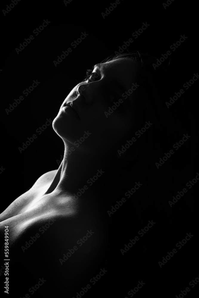 face of girl on a dark background with a back light