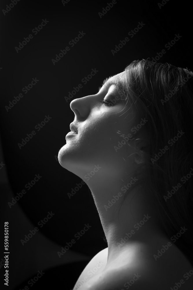 face of girl on a dark background with a back light