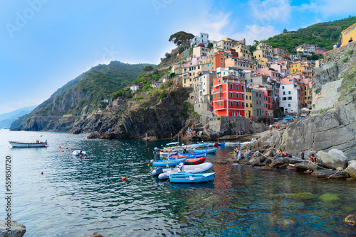 Riomaggiore picturesque town with moored boats of Cinque Terre, Italy