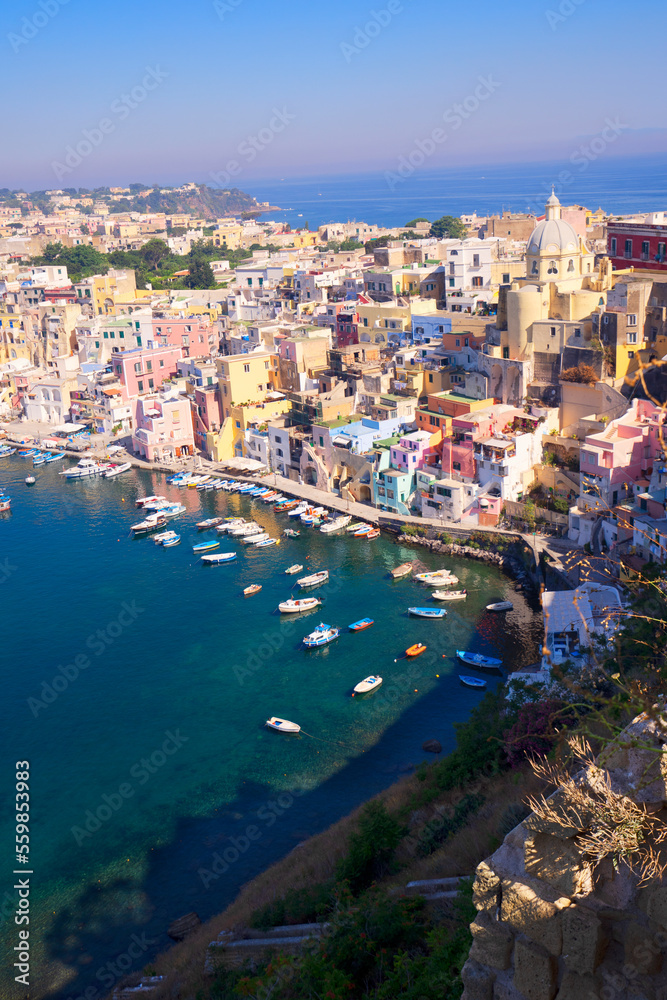 Procida island colorful town with small harbour from above, Italy